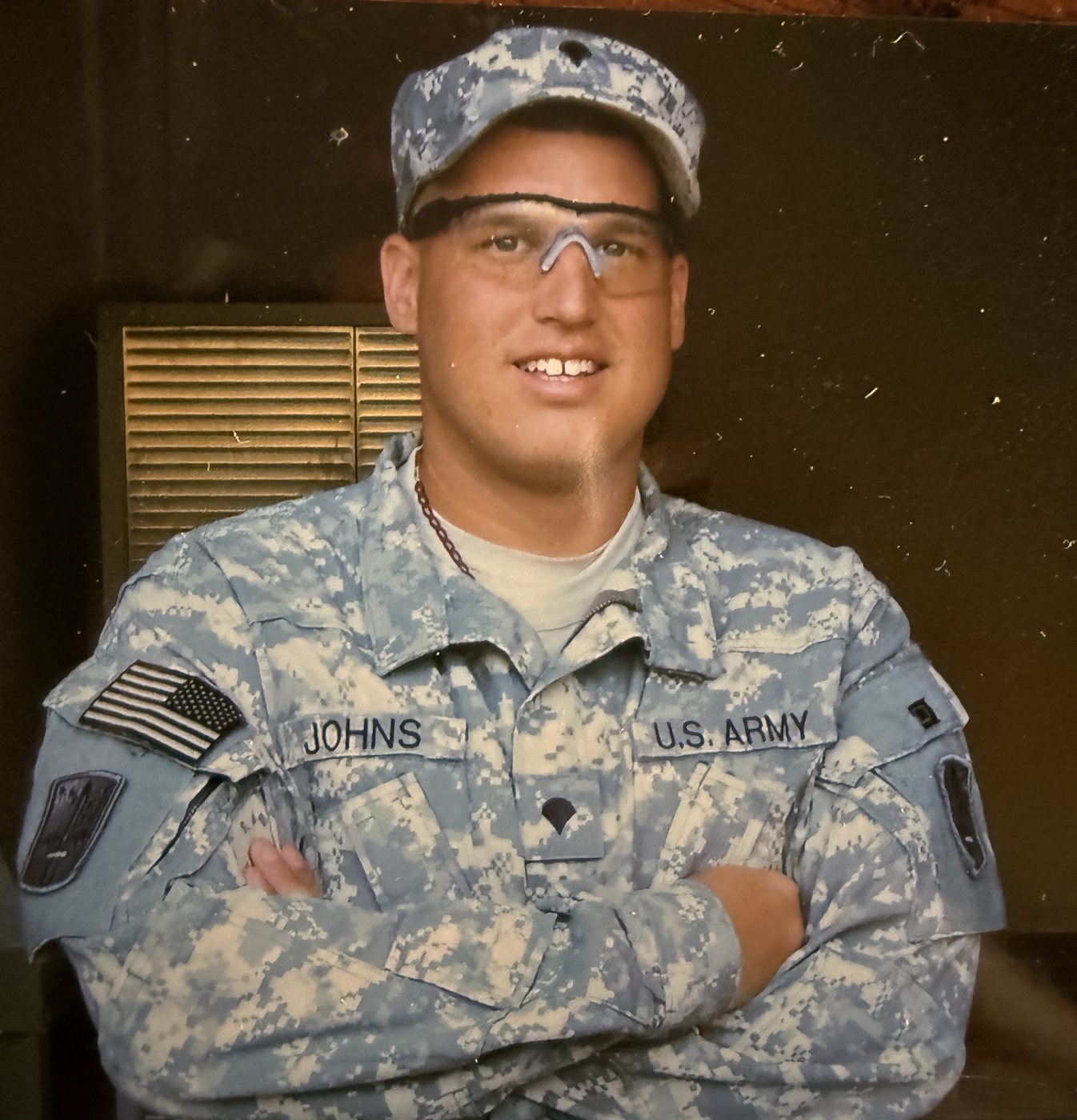 Heath in US Army combat uniform with arms crossed